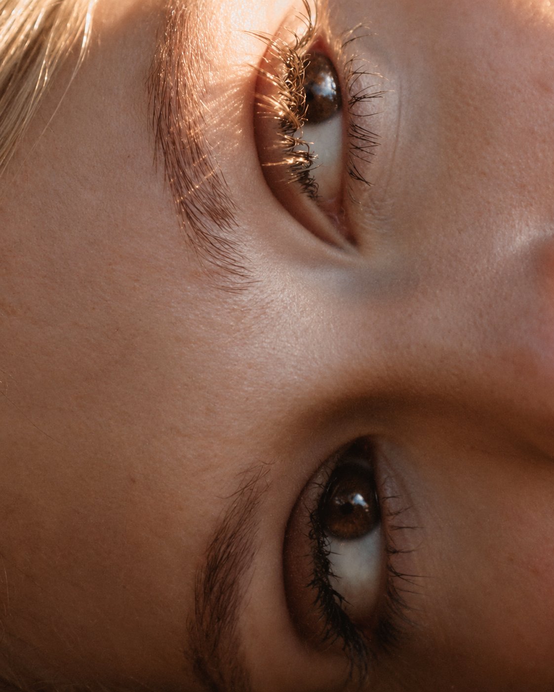 Close-up of a person's eyes in warm golden light